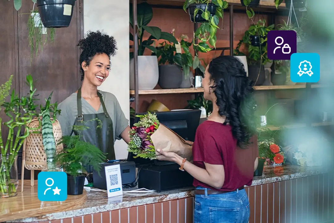 Proprietária de uma floricultura atendendo uma cliente satisfeita, ilustrando a importância de fidelizar uma base de clientes sólida.